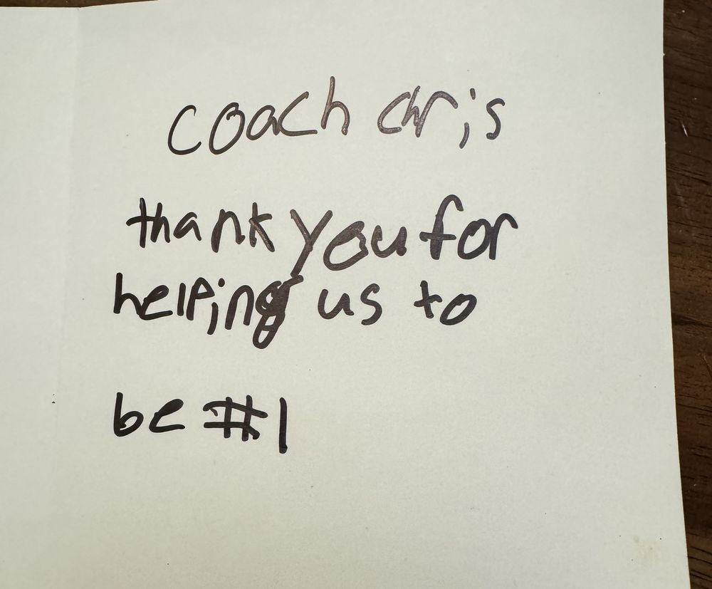 A handwritten card from a player: Coach Chris, thank you for helping us to be number 1